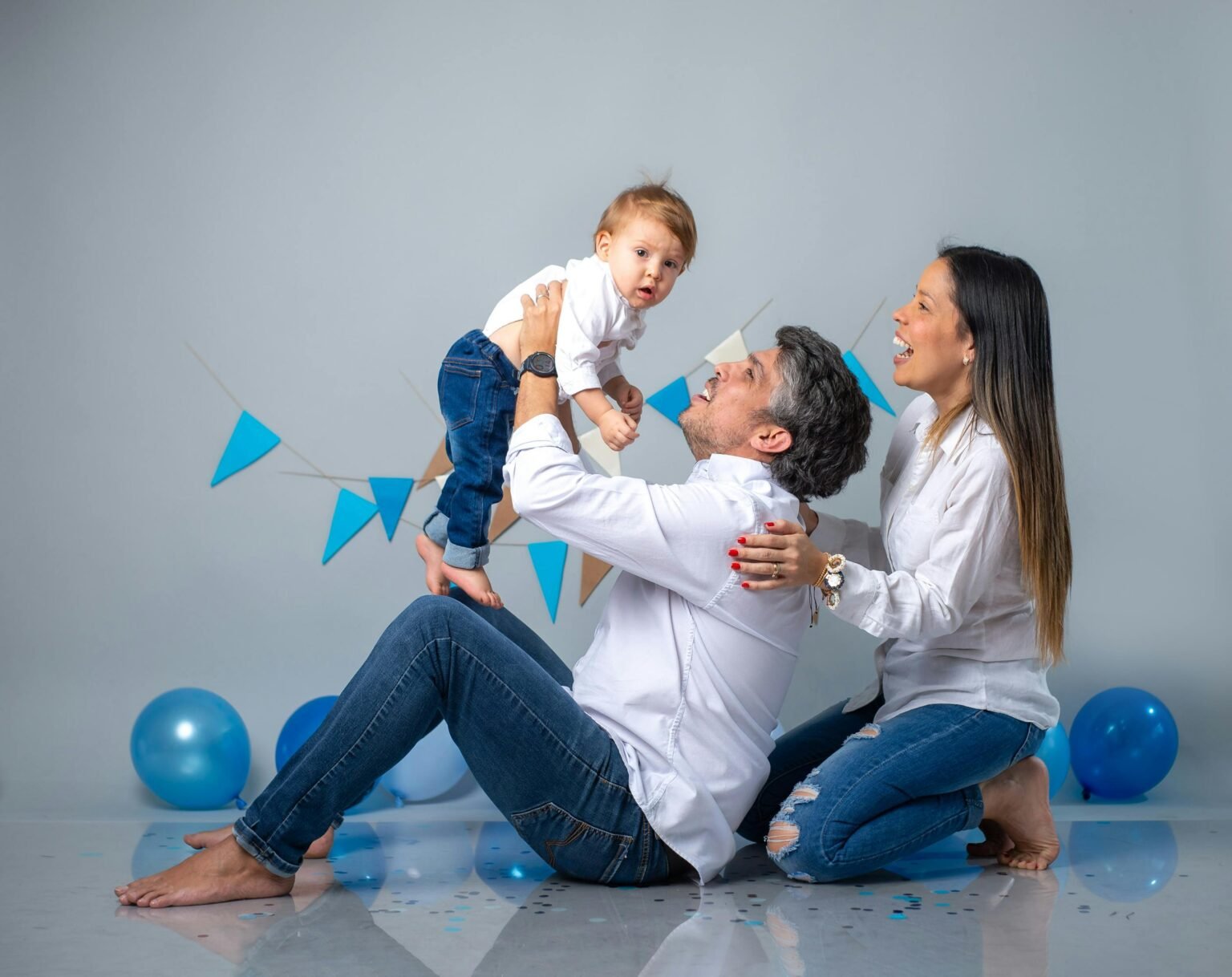Joyful family playing with balloons and celebrating indoors.